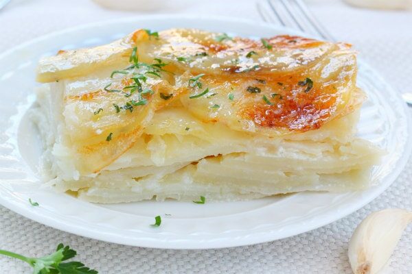 serving of scalloped garlic potatoes on a plate