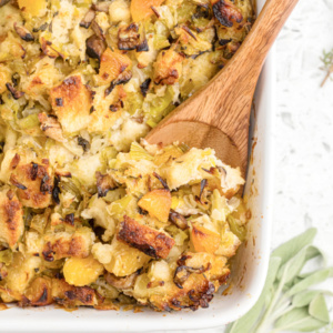 casserole dish of shiitake mushroom stuffing with wooden spoon