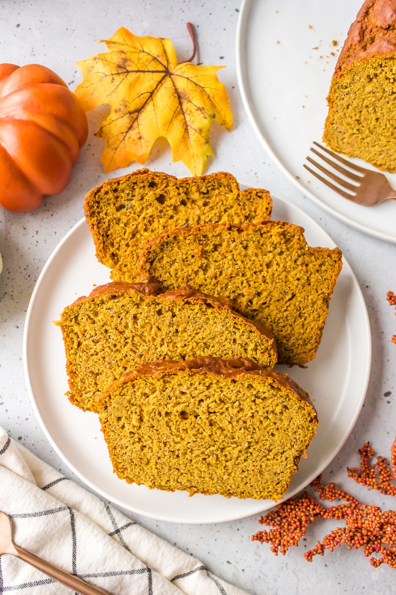 four slices of spicy whole wheat pumpkin banana bread on a plate