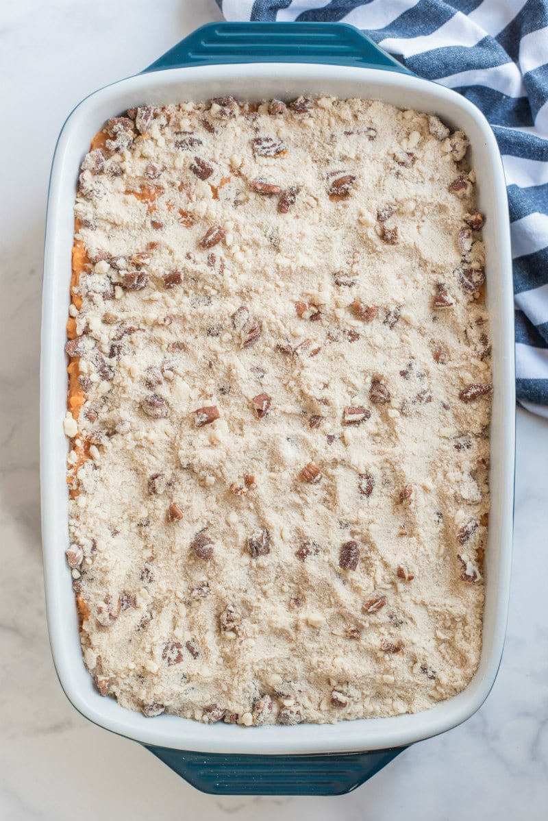 streuseled sweet potato casserole in white dish ready for oven