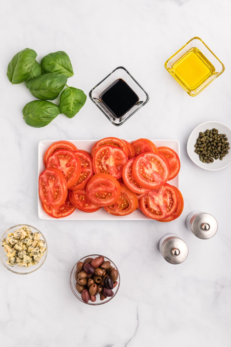 ingredients displayed for making tomato caper and blue cheese salad