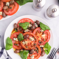 tomato caper and blue cheese salad on a plate