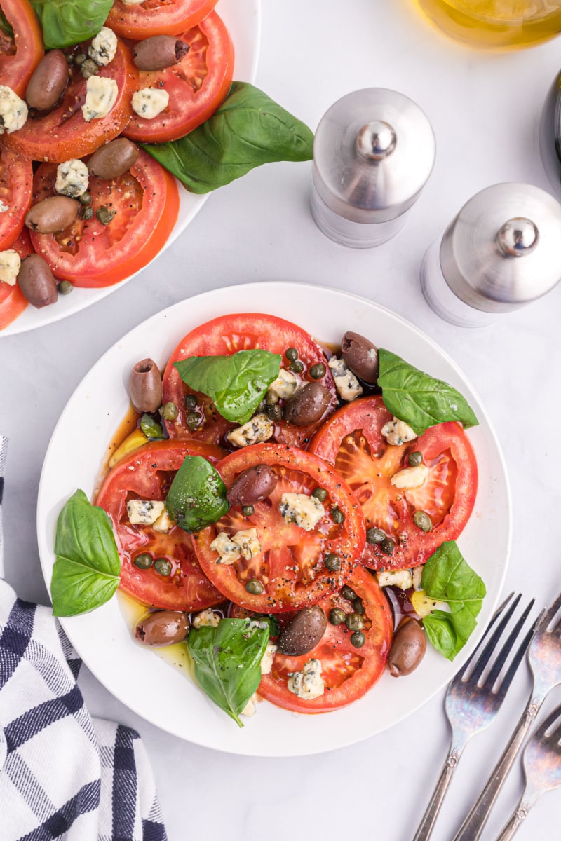 tomato caper and blue cheese salad on a plate