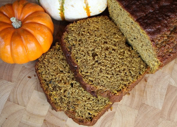 Spicy Whole Wheat Pumpkin Banana Bread cut into slices with little fresh pumpkins