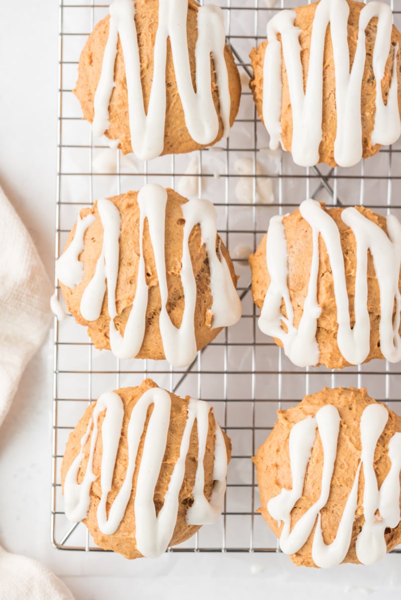 pumpkin muffins with icing on a baking rack