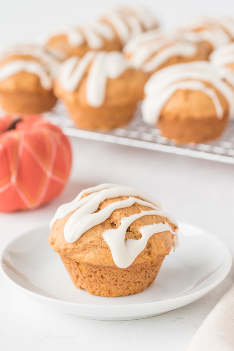 whole wheat pumpkin spice muffin on a plate with glaze