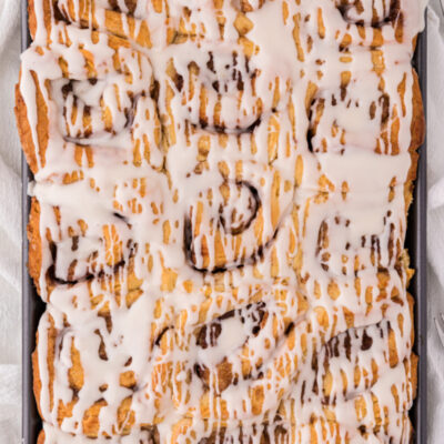 pan of cinnamon rolls with icing on top