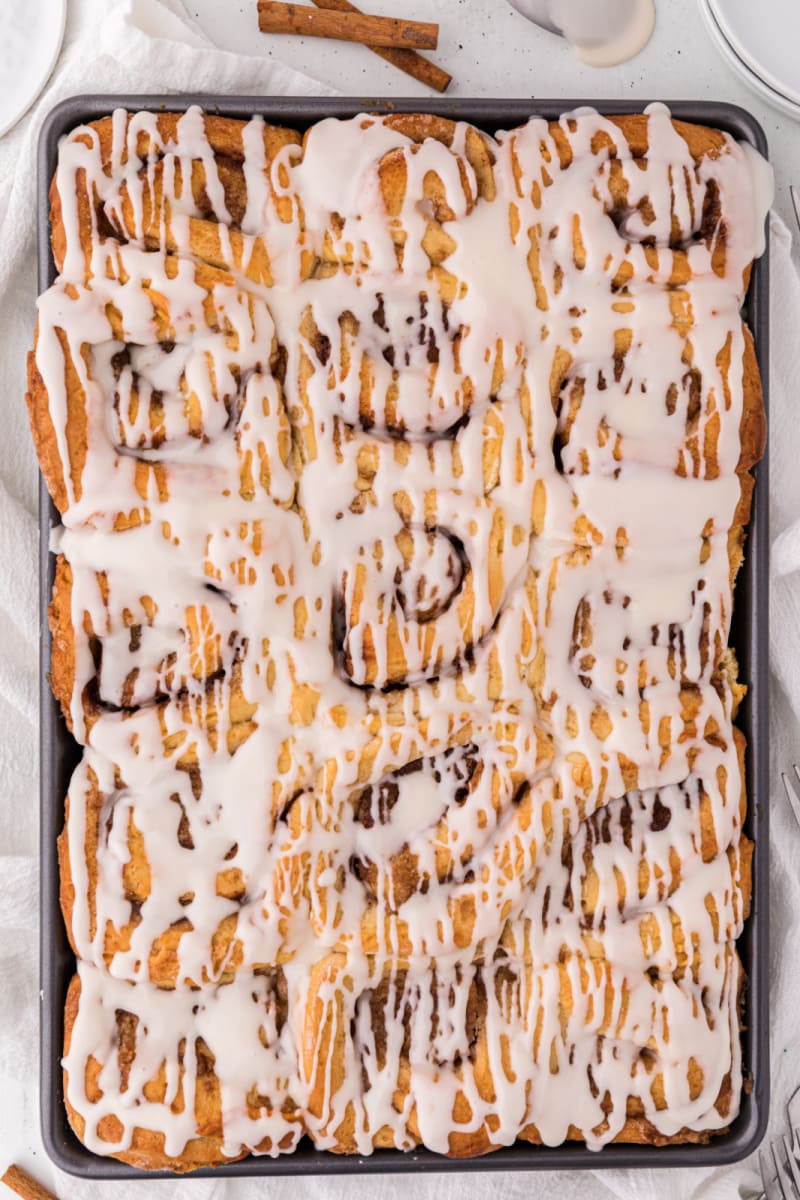pan of cinnamon rolls with icing on top