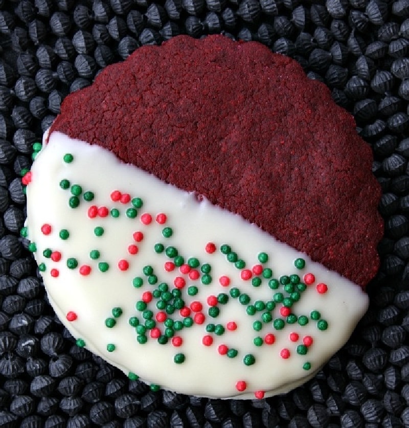 Red Velvet Shortbread Cookies recipe from RecipeGirl.com #redvelvet #shortbread #cookies #recipe #RecipeGirl red velvet shortbread cookie dipped in white chocolate
