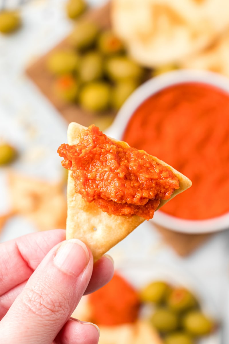 cracker with roasted red pepper almond spread on it