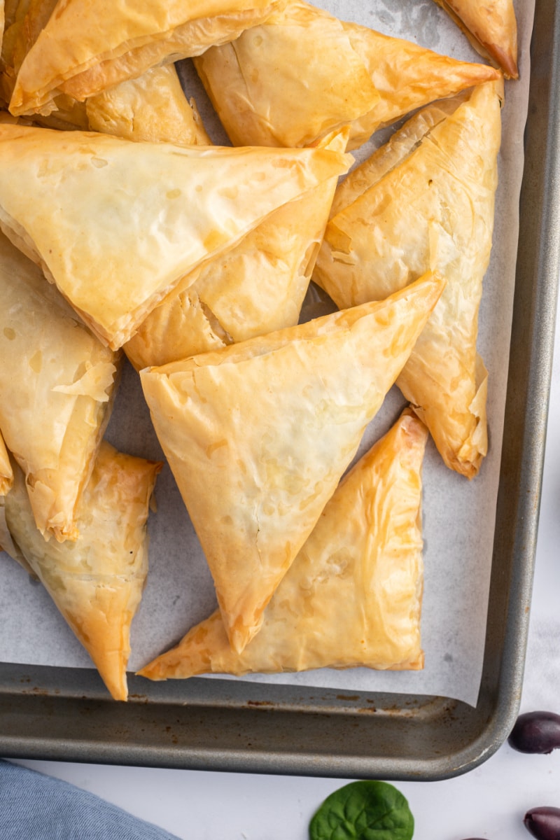 spinach phyllo triangles on baking sheet