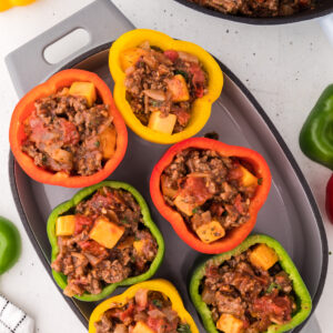 ground beef stuffed peppers in a baking dish