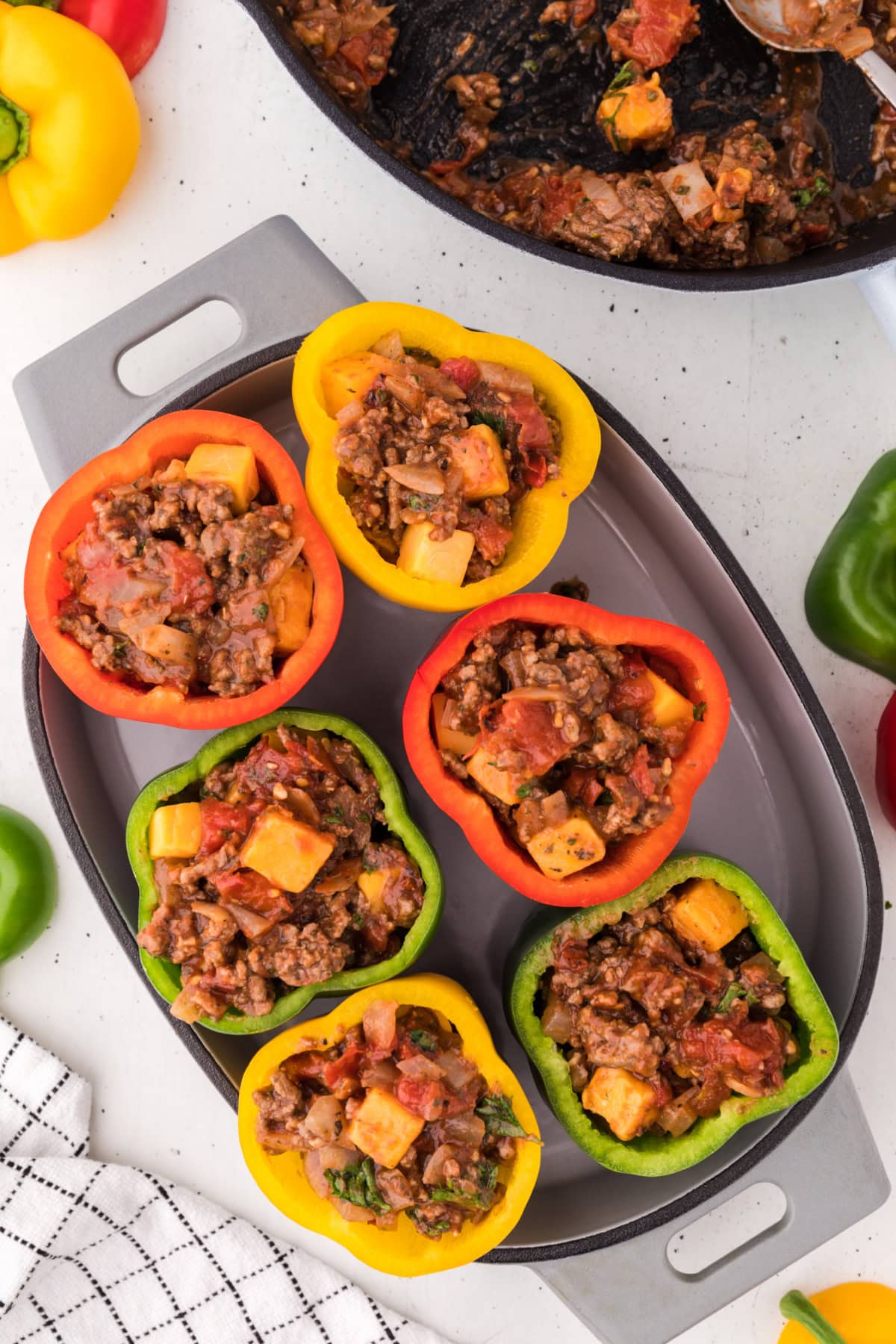 ground beef stuffed peppers in a baking dish
