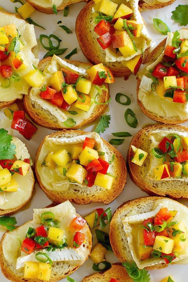 overhead shot of peach and brie bruschetta displayed on a serving platter