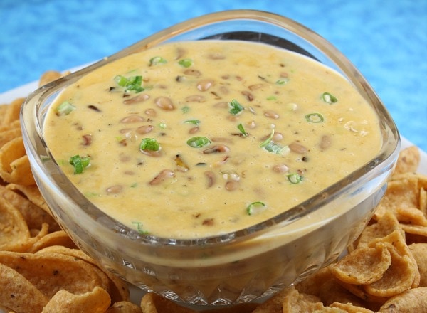 bowl of cheesy black eyed pea dip surrounded by chips