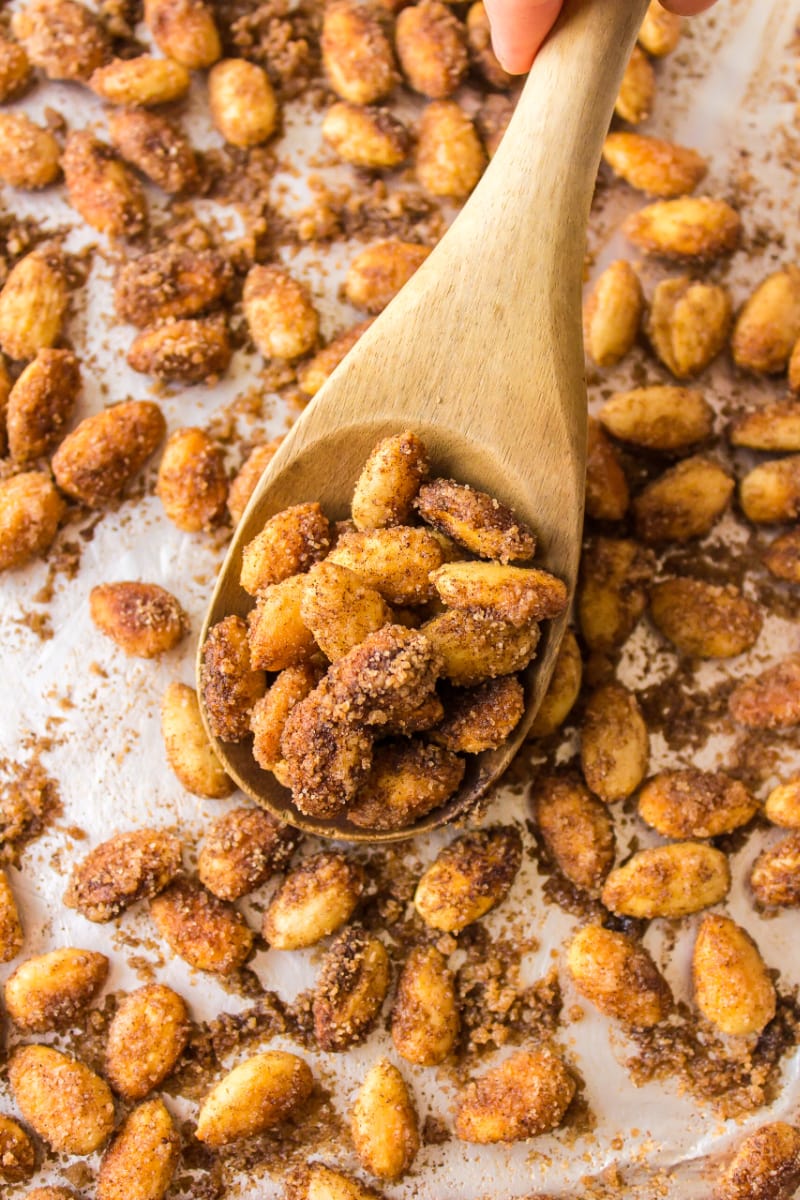 wooden spoon full of cinnamon glazed almonds