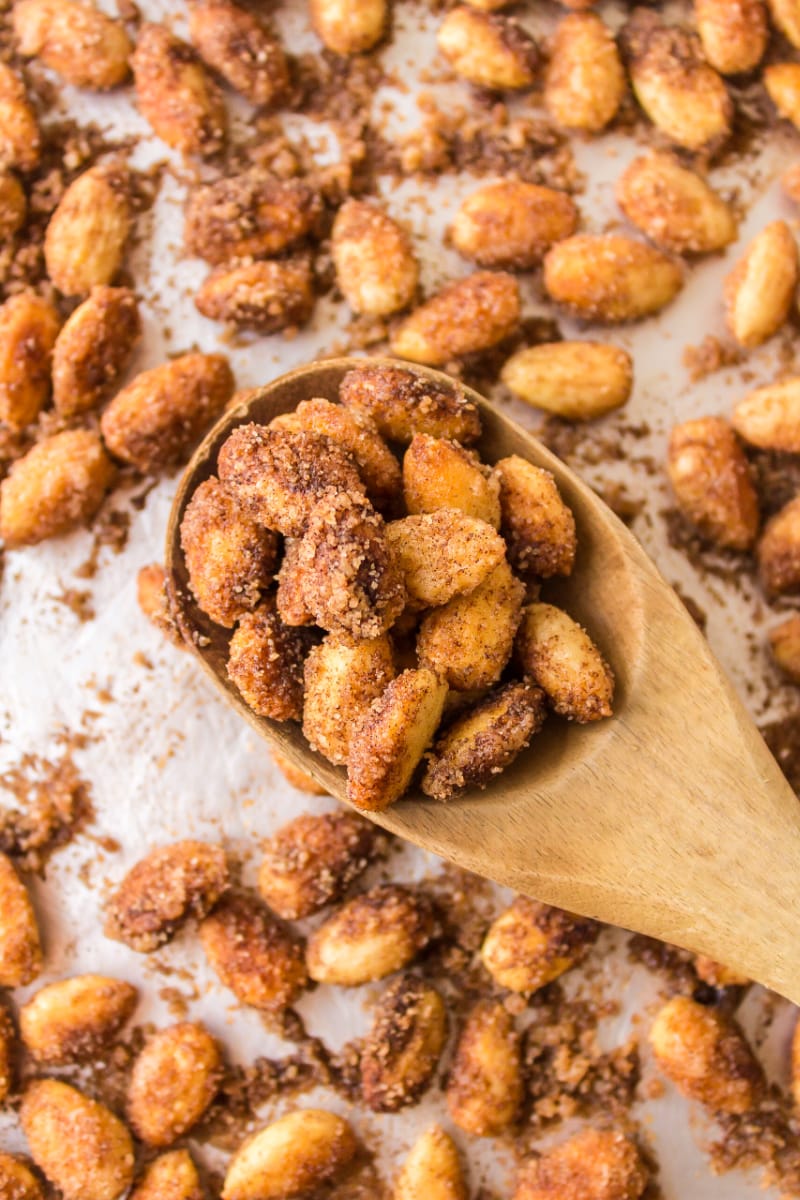 wooden spoon full of cinnamon glazed almonds