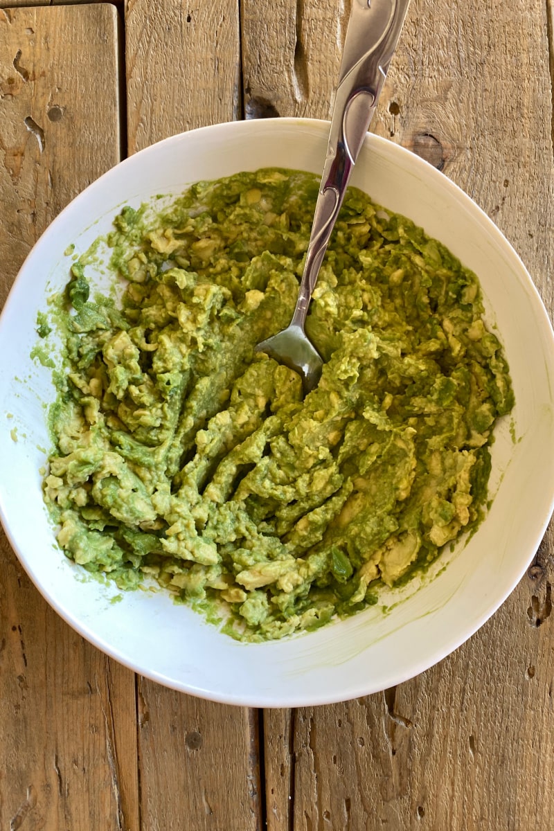 mashed avocado in white bowl