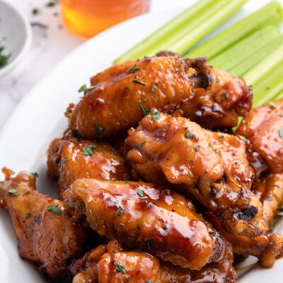 honey glazed chicken wings on platter with celery