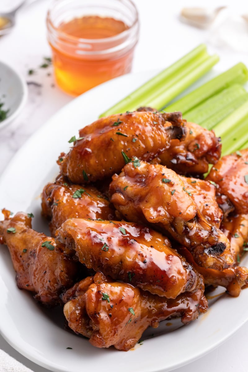 honey glazed chicken wings on platter with celery