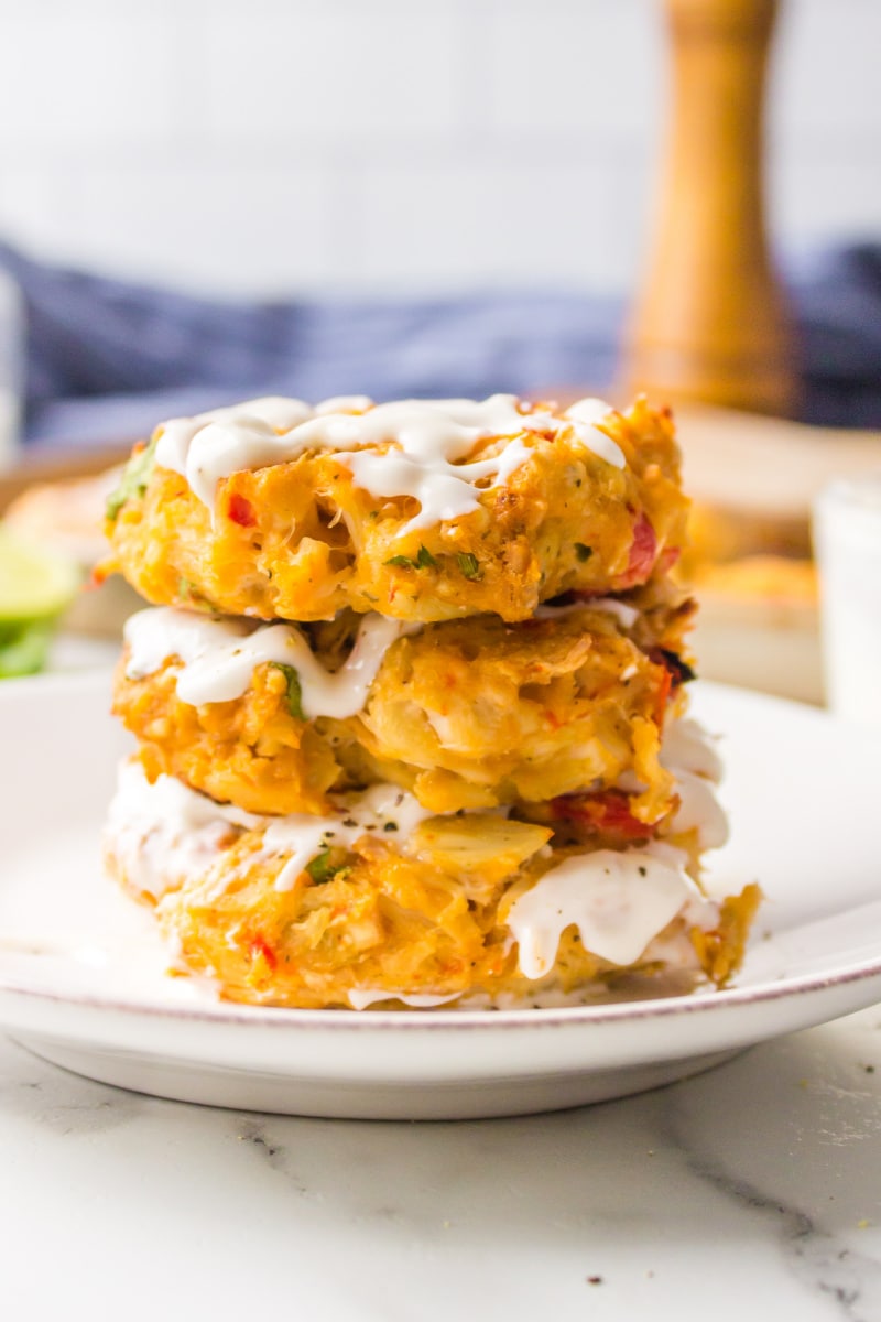 stack of three crab cakes with sauce