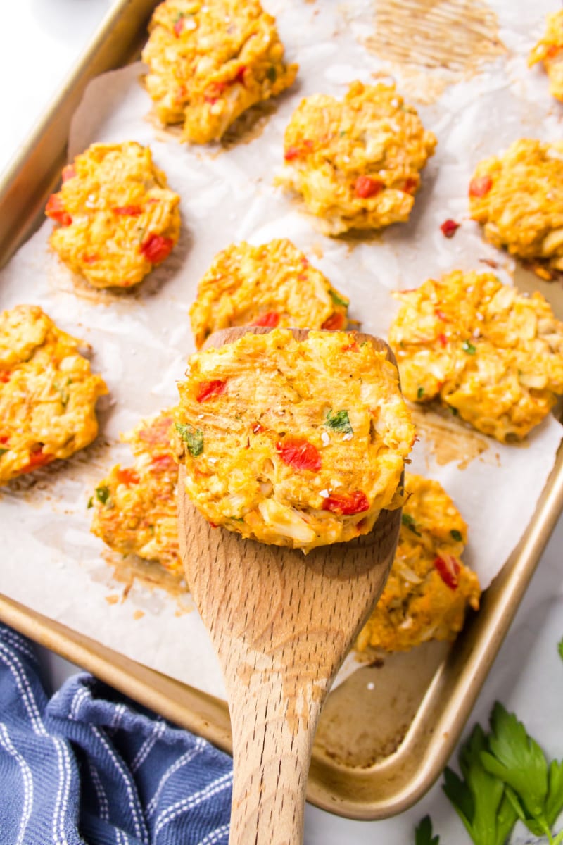 spooning crab cake off baking sheet