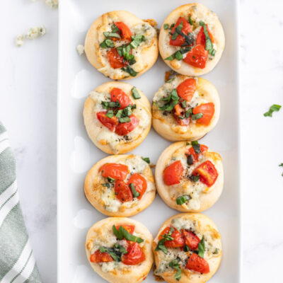 platter of pizzette with gorgonzola tomato and basil