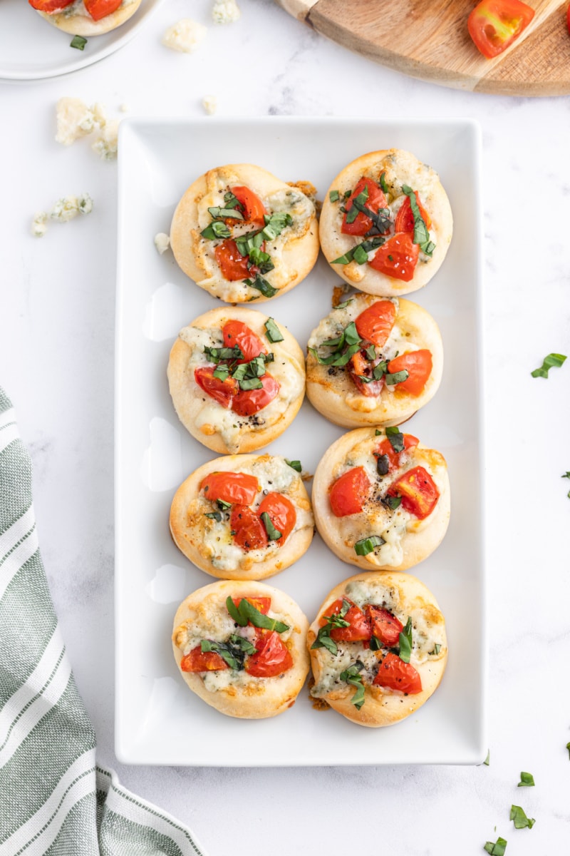 platter of pizzette with gorgonzola tomato and basil