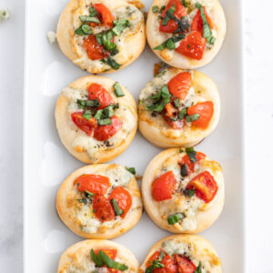 pinterest image for pizzette with gorgonzola tomato and basil