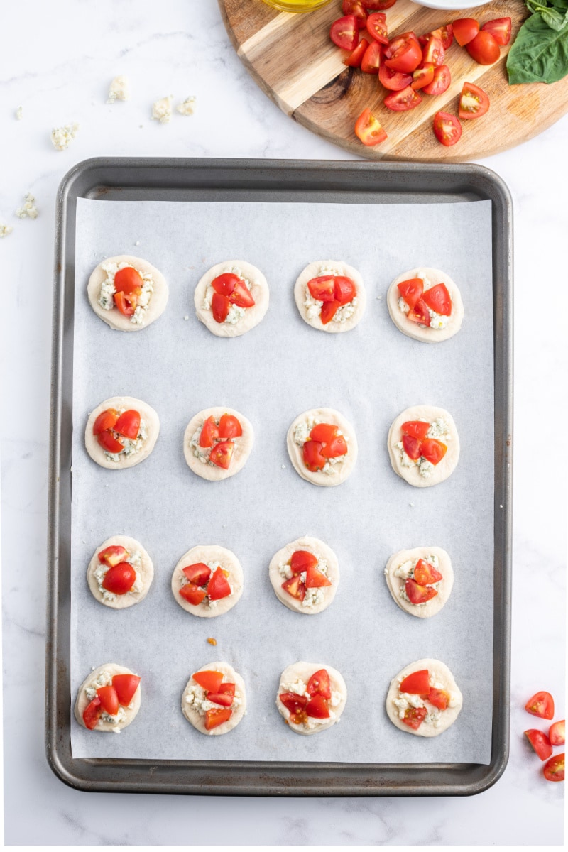 pizzette appetizers on a baking sheet