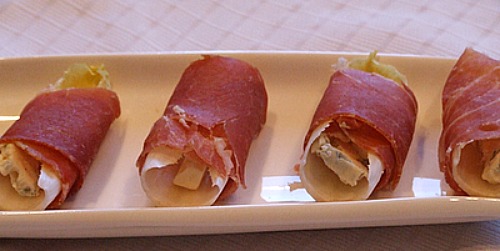 Prosciutto Wrapped Endive with Blue Cheese and Pear on a platter