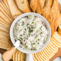 vegetable goat cheese spread in bowl with crackers