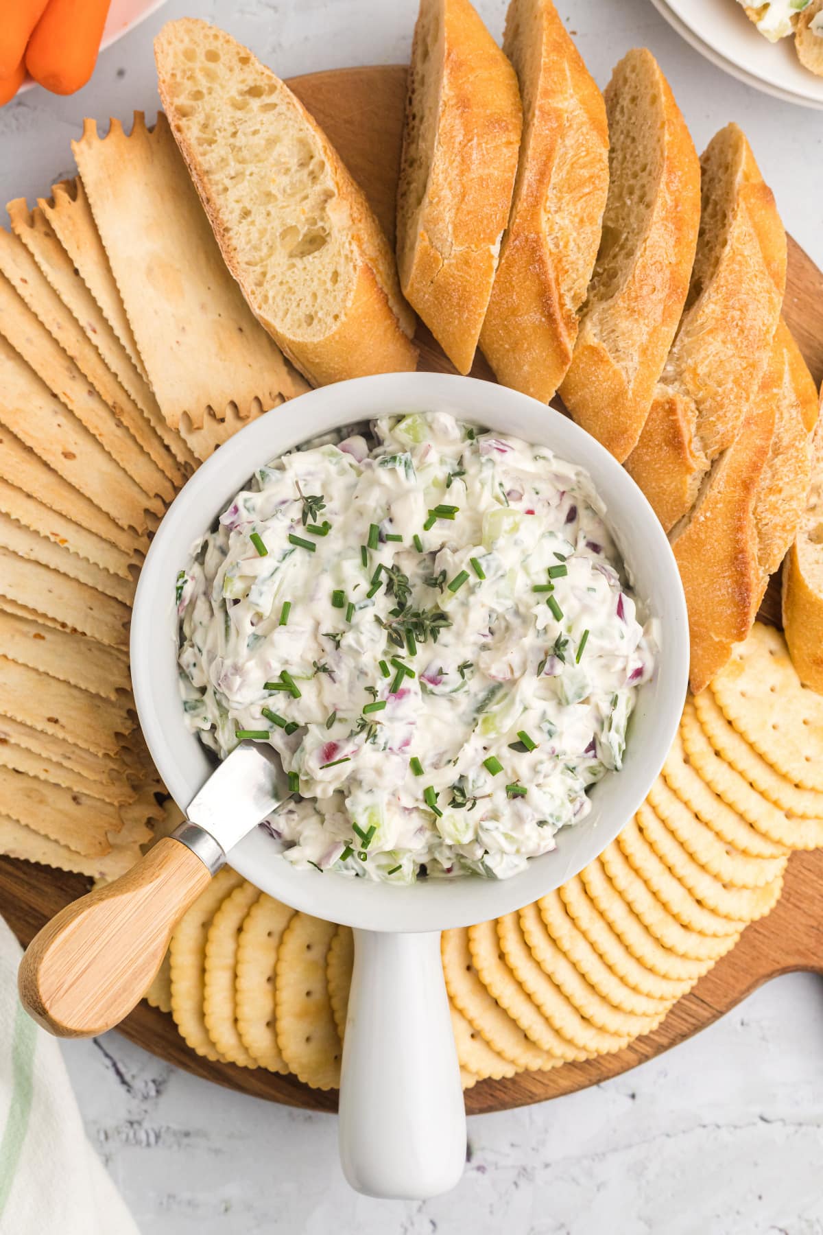 vegetable goat cheese spread in bowl with crackers