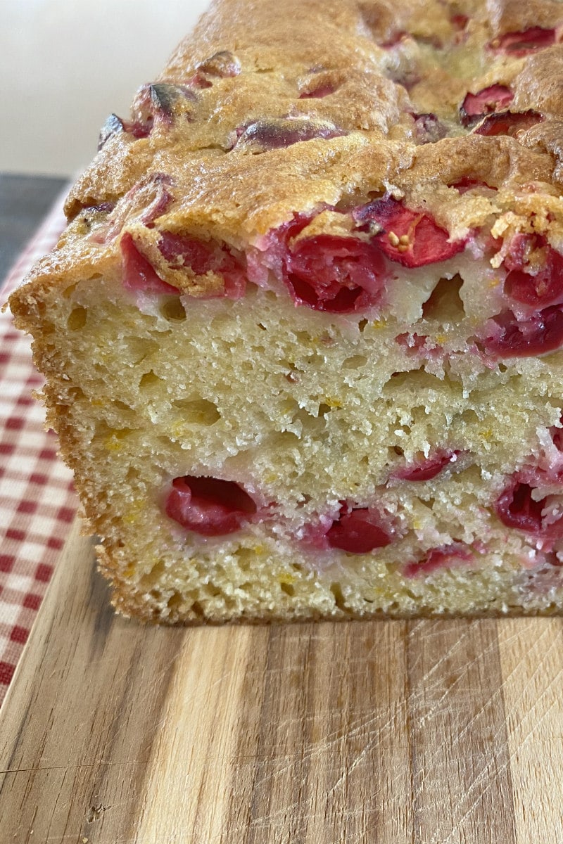 sliced open cranberry orange bread on wood board