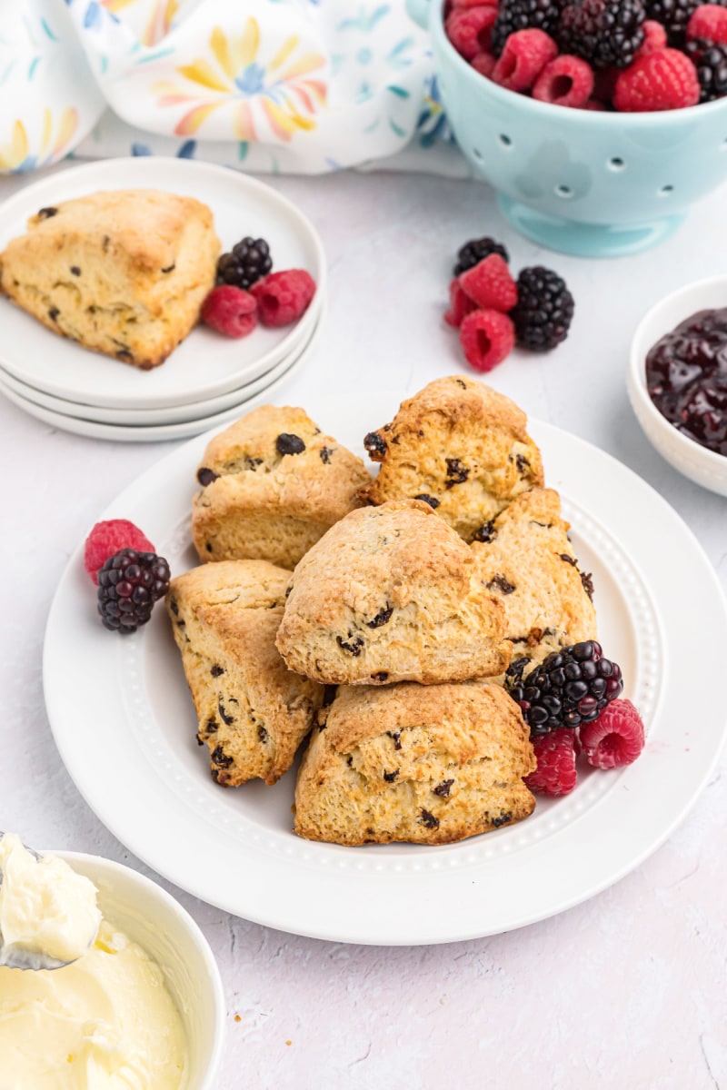 pile of cream scones and berries on a plate