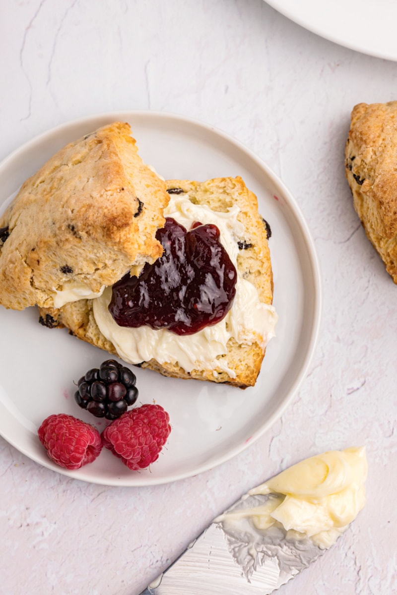 scone cut open with butter and jam