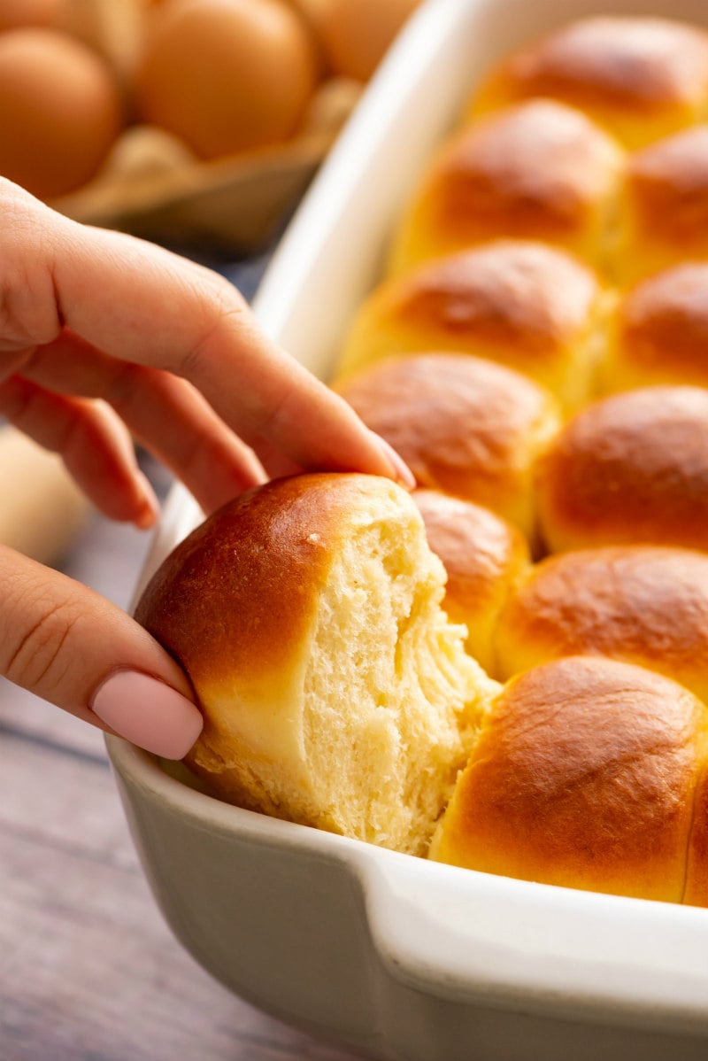 pulling Easy Dinner Rolls out of the pan