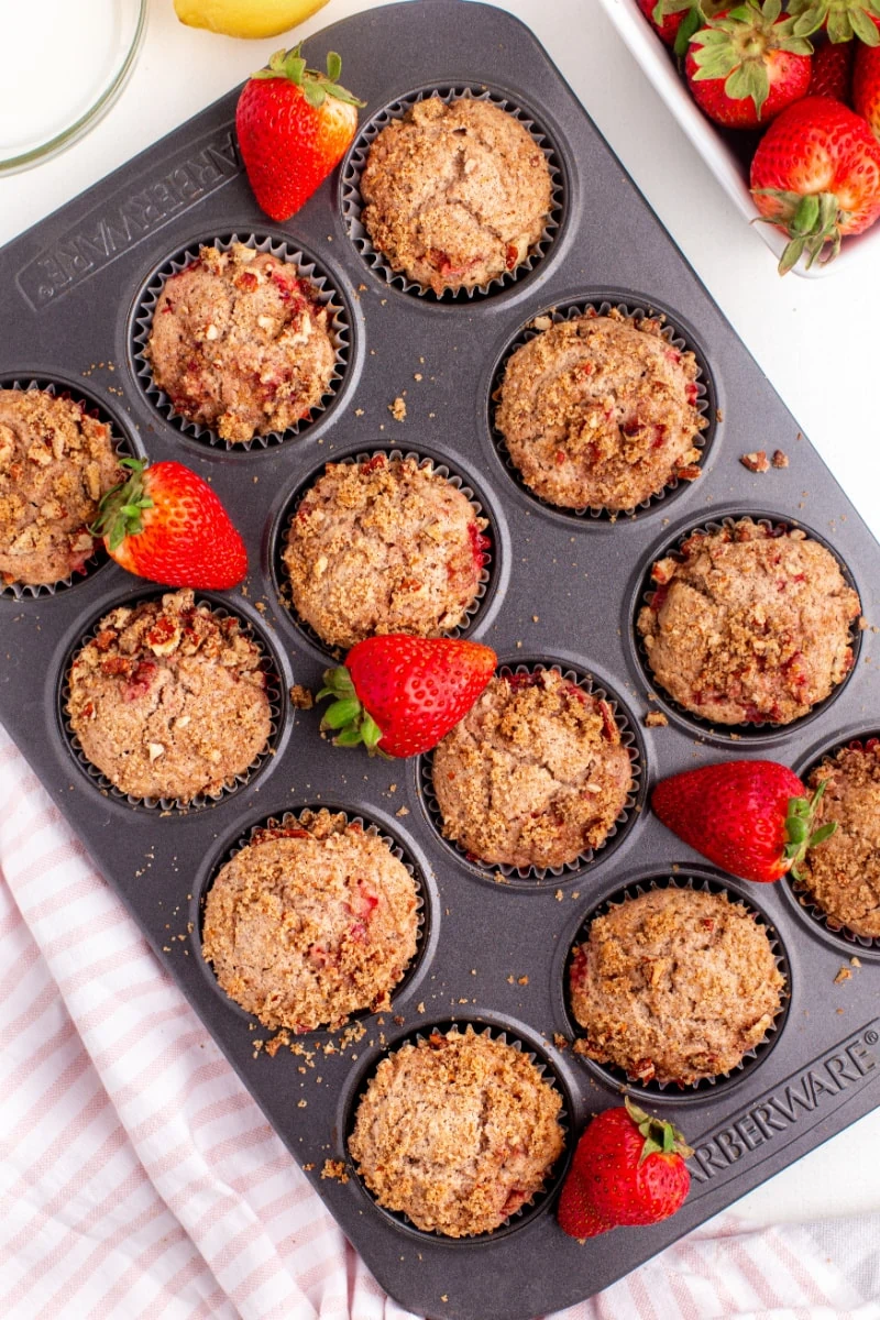 streusel topped strawberry muffins in a muffin pan