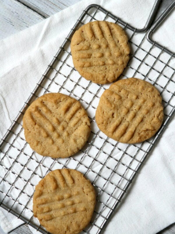 four gluten free dairy free peanut butter cookies on rack