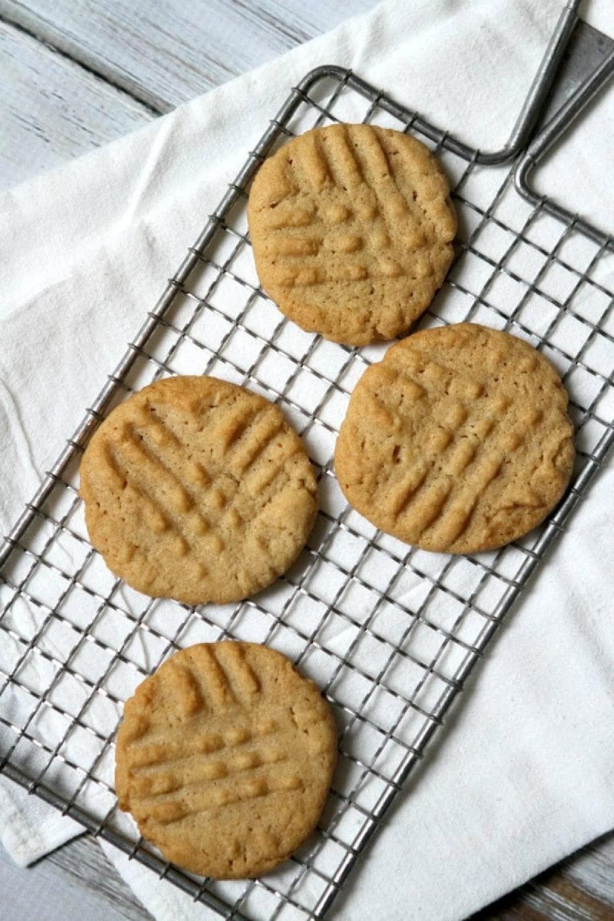 four gluten free dairy free peanut butter cookies on rack