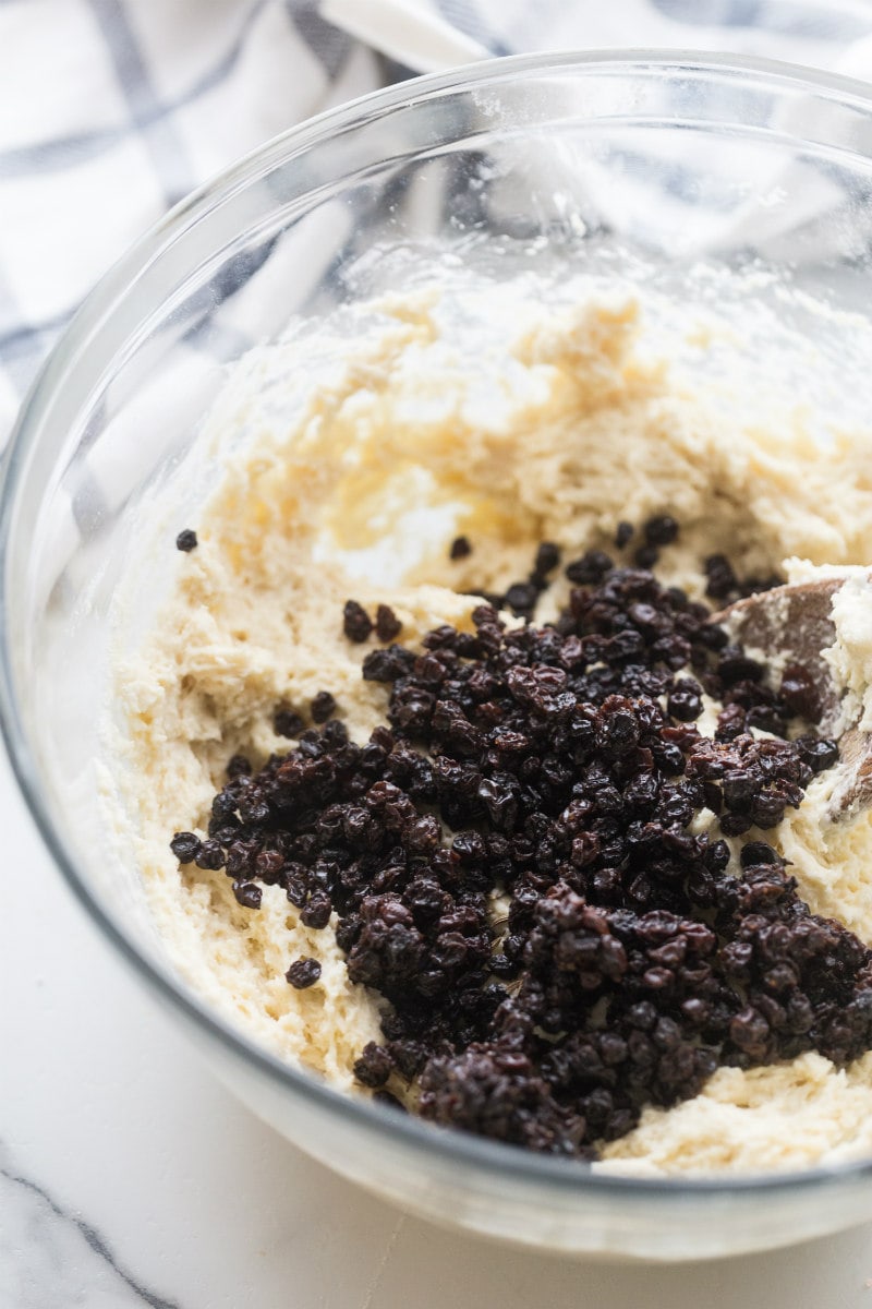 adding currants to Irish Soda Bread Muffins batter