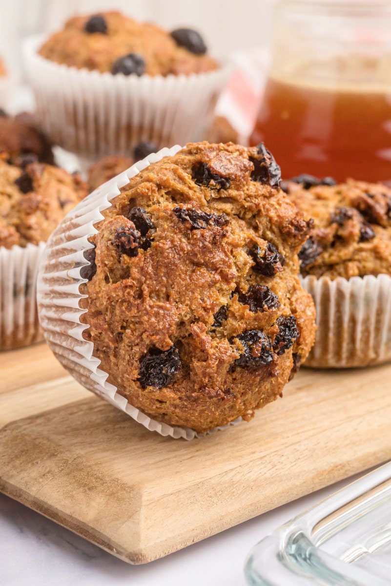 bran muffin on its side on wooden cutting board