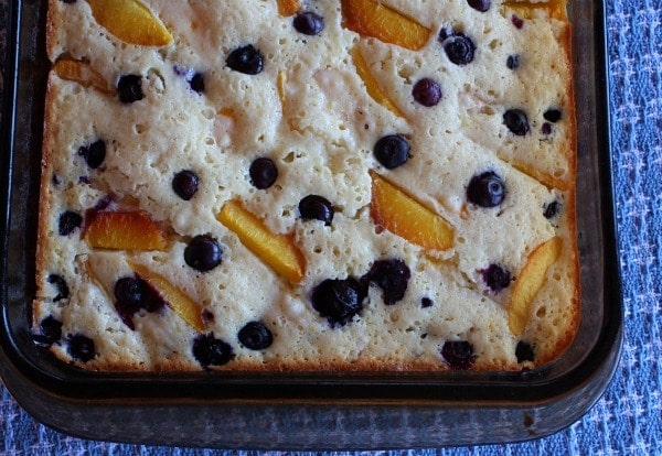 Overhead shot of half of the pan of peach and blueberry coffee cake