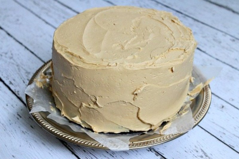 Easy Creamy Peanut Butter Frosting recipe from RecipeGirl.com #easy #creamy #peanut #butter #peanutbutter #frosting #recipe #RecipeGirl Creamy Peanut Butter Frosting on a two layer cake