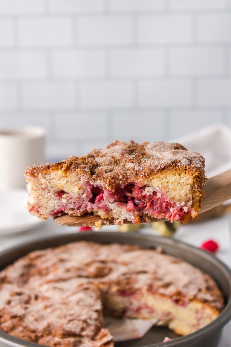 spatula scooping up slice of raspberry coffee cake