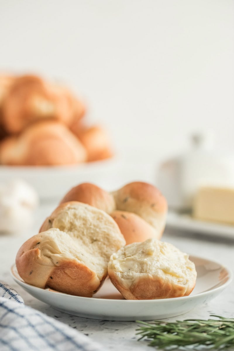 cloverleaf rolls on a white plate pulled apart