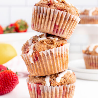 three glazed strawberry lemon streusel muffins stacked