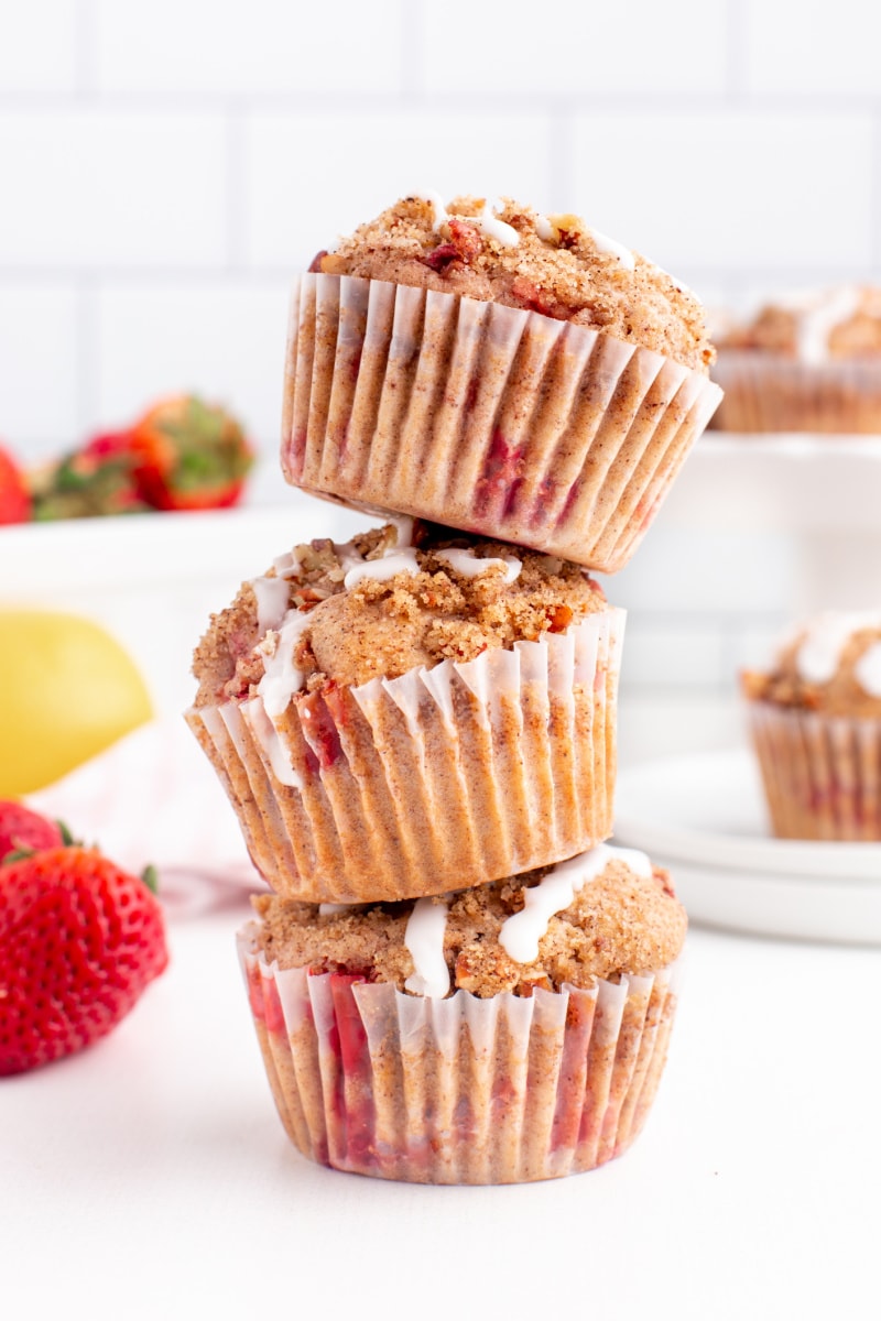 three glazed strawberry lemon streusel muffins stacked