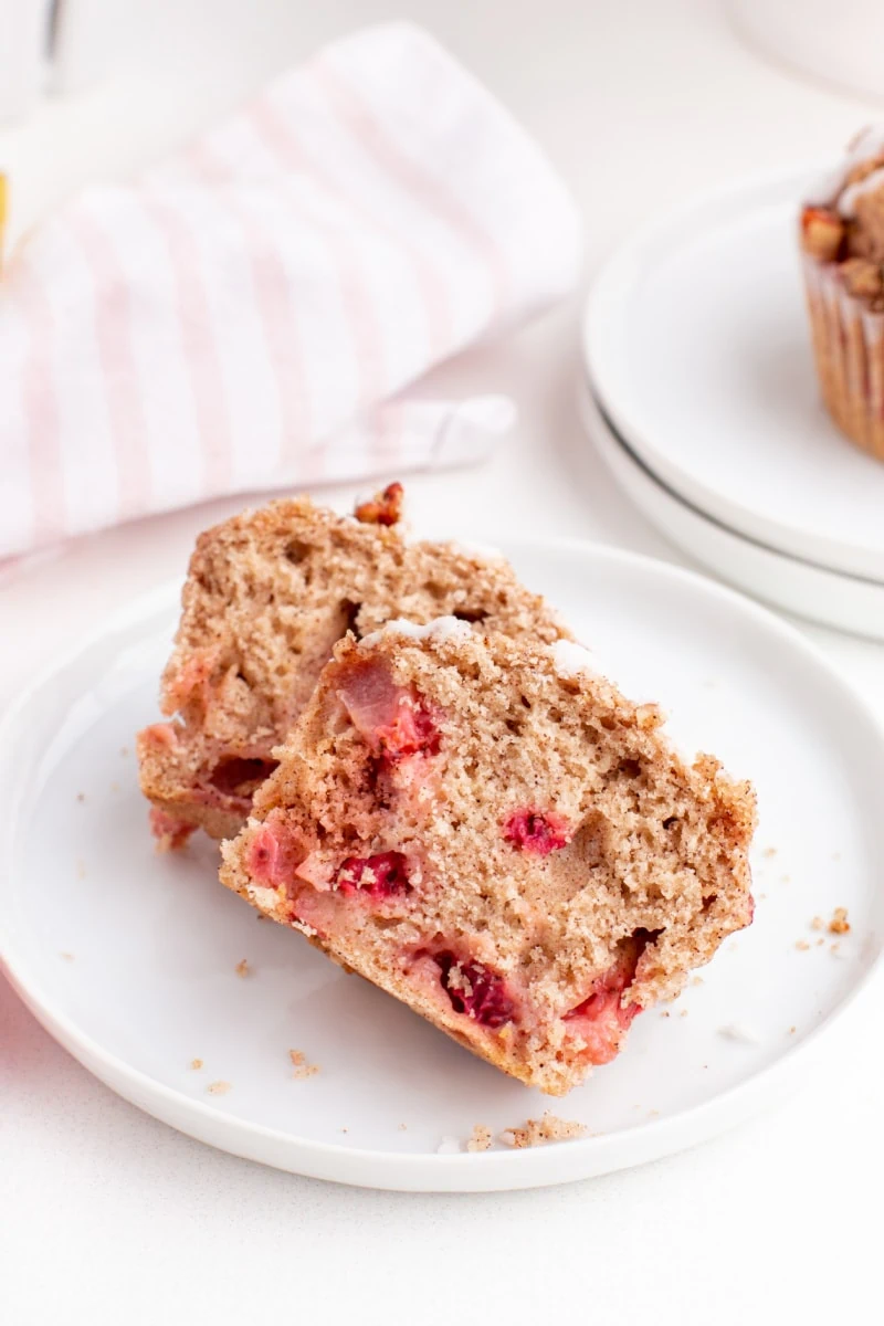 strawberry muffin cut in half on a plate