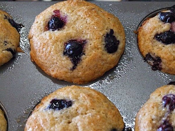 blueberry maple muffins in a muffin pan